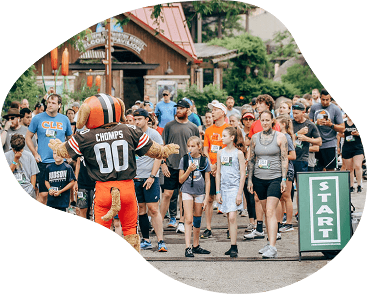 Group of people entertained by team mascot