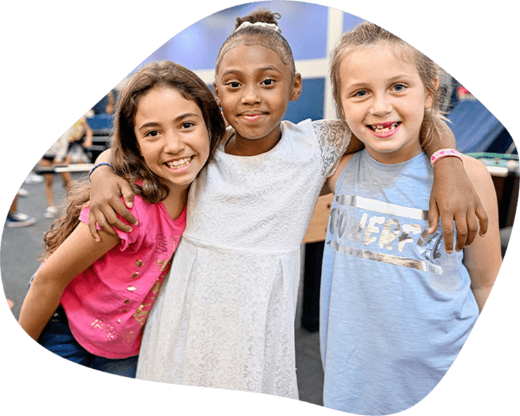 Three girls hugging