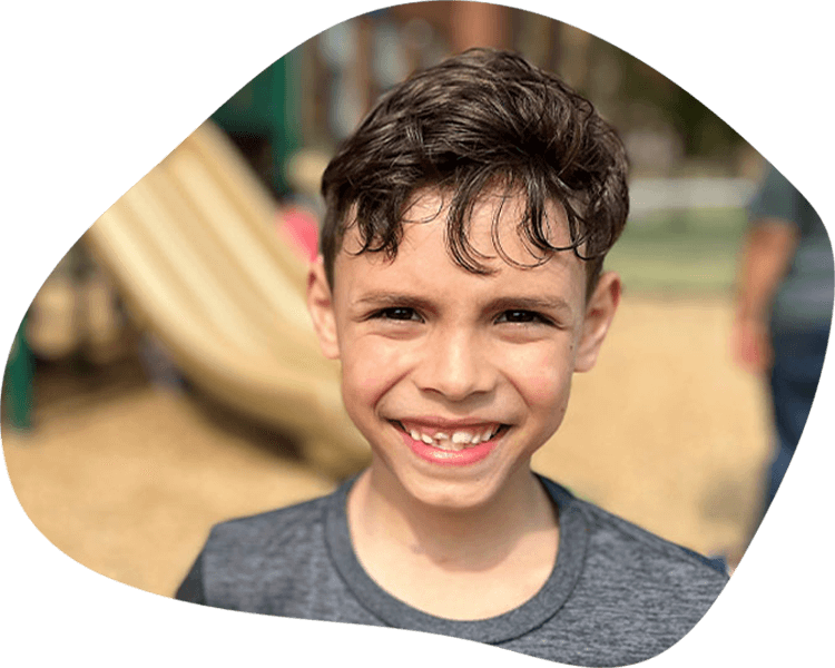 Boy in kid's park smiling